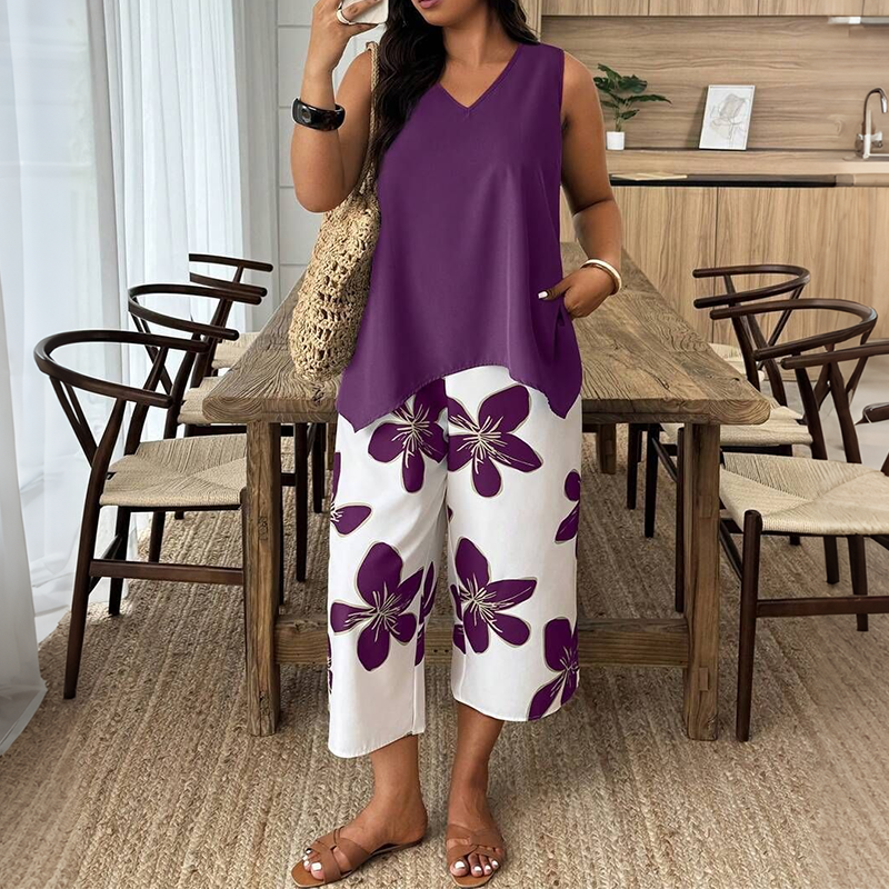 ✨ Women's outfit consisting of an asymmetric top and floral patterned capri trousers: versatile, colorful, and comfortable 🌺