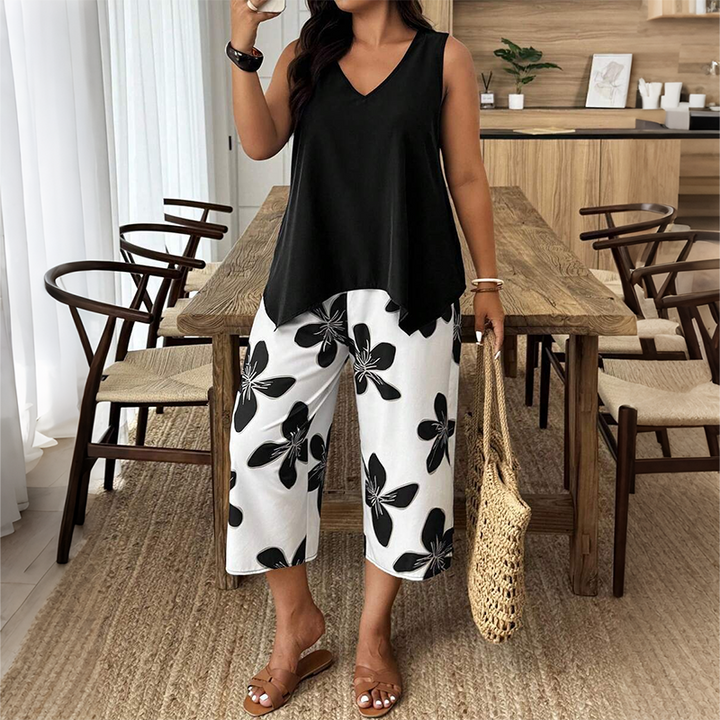 ✨ Women's outfit consisting of an asymmetric top and floral patterned capri trousers: versatile, colorful, and comfortable 🌺